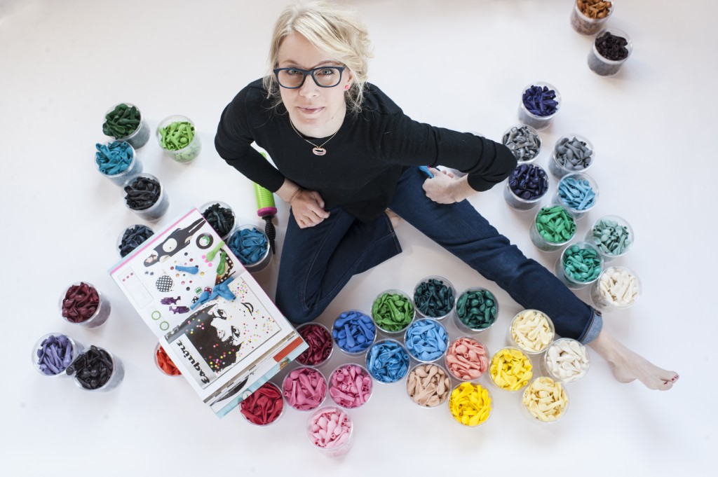 The lady of the hour, Elaine Frei, poses amongst Luft Balloons in several lovely colors.